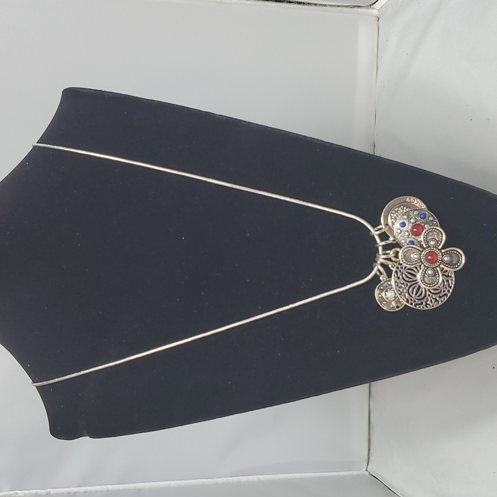 Ruff hewn silver necklace with charms